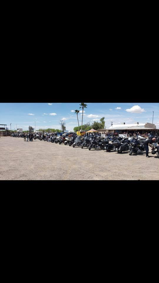 Long line of motorcycles filling the Desert Rose Bar & Grill lot during a weekend bike rally in Arlington, Arizona
