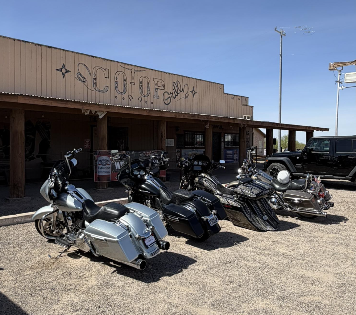Motorcycles parked in front of the Desert Rose Bar & Grill storefront off Historic Old US 80 in Arlington, Arizona